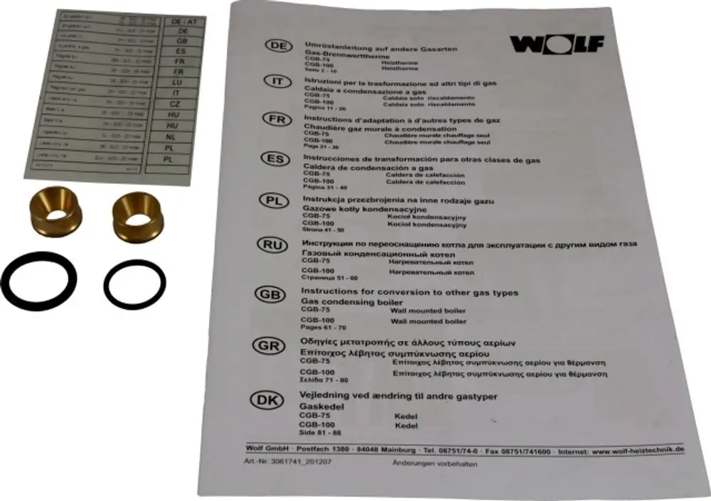 Wolf Umrüstsatz für Gasgeräte, bestehend aus verschiedenen Bauteilen wie Messingringen und Dichtungen, sowie mehrsprachiger Anleitung zur Umrüstung auf andere Gasarten.
